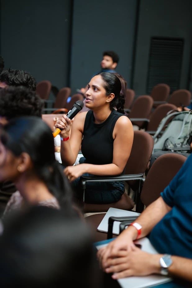 Attendee asking a question from the audience during Q&A